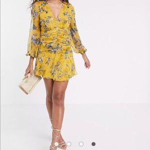 Beautiful long sleeve floral mini dress with cluster embellishment.